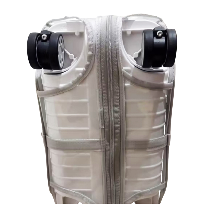 Bottom view of the clear Fixmeuniva cover on a Rimowa Hybrid Check-In M, showing the zipper and wheel openings.